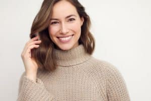 Young female girl with a perfect smile wearing sweater