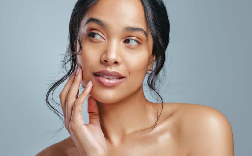 Beautiful woman with smooth, radiant skin after getting a microneedling or chemical peel treatment.