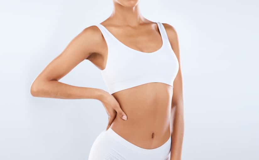 Close up of a gorgeous, fit young woman with defined curves after getting liposuction treatment.